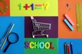 Empty grocery cart surrounded by school supplies on bright colorful background