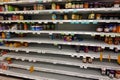 Empty grocery store shelves of peanut butter before a hurricane or snow storm