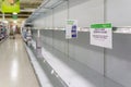 Empty grocery store shelves at Publix fully out of stock of all supplies including toilet paper, paper products, and bathroom Royalty Free Stock Photo