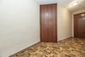 Empty hall with sintasol type wooden floor, white painted walls,