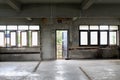 Empty hallway in abandon building interior with cement wall and broken window. Royalty Free Stock Photo