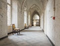 Empty hallway with chairs in an abandoned monastery