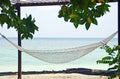 Beachfront hammock facing blue ocean on beach tropical island