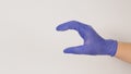 Empty Hand holding or catch nothing guesture on white background.Hand wear violet or purple latex glove