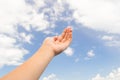 Empty hand palm on the blue sky with clouds Royalty Free Stock Photo