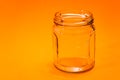 Empty Hexagonal Glass Flask Isolated On Orange Bottom. Kitchen Utensils