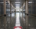 Empty high school hallway with one way sign on floor