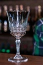 Empty high stem glass crystal glass on wooden counter in bar