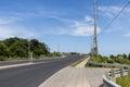 Empty highway - blue sky - green trees - power lines - guard rail Royalty Free Stock Photo