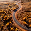 An empty highway is captured from a top-down perspective, offering an aerial view of the great landscape it traverses