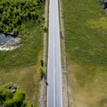 An empty highway is captured from a top-down perspective, offering an aerial view of the great landscape it traverses