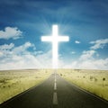 Empty highway with a cross