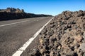 Empty highway is among lava piles. Asphalt road leading to the Teide volcano on the Tenerife island. Canary Islands, Spain Royalty Free Stock Photo