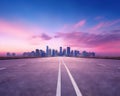 an empty highway road to the city in the early morning. Royalty Free Stock Photo