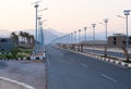 Empty highway between row of solar panels on the lanterns and pa Royalty Free Stock Photo