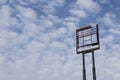 Empty highway tall sign frame against a blue sky with clouds, copy space Royalty Free Stock Photo