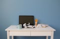 Empty home office of creative entrepreneur with black laptop on white table during lunch break. Modern workspace with Royalty Free Stock Photo
