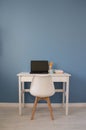 Empty home office of creative entrepreneur with black laptop on white table during lunch break. Modern workspace with Royalty Free Stock Photo