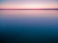 Empty horizon over water at dusk. nothing but water and clear sk