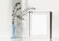 Empty horizontal frame mockup in modern minimalist interior with plant in trendy vase on white wall background. Royalty Free Stock Photo