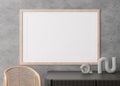 Empty horizontal picture frame on concrete wall in modern living room. Mock up interior in minimalist, contemporary Royalty Free Stock Photo