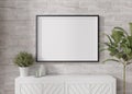 Empty horizontal picture frame on white brick wall in modern living room. Mock up interior in minimalist, contemporary Royalty Free Stock Photo