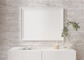Empty horizontal picture frame on white brick wall in modern living room. Mock up interior in minimalist, contemporary Royalty Free Stock Photo