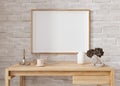 Empty horizontal picture frame on white brick wall in modern living room. Mock up interior in minimalist, contemporary Royalty Free Stock Photo