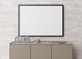 Empty horizontal picture frame on white brick wall in modern living room. Mock up interior in minimalist, contemporary Royalty Free Stock Photo