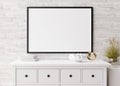 Empty horizontal picture frame on white brick wall in modern living room. Mock up interior in minimalist, scandinavian Royalty Free Stock Photo