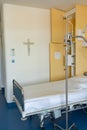 Empty hospital bed with intravenous drip in hospital ward
