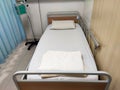 An empty hospital bed. It is in a state of readiness to accept patients. Royalty Free Stock Photo