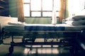 Empty hospital bed with sunlight from the window,vintage tone