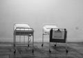 Empty hospital beds standing in abandoned room for patients