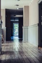 Empty Hotel Hallway with Wooden Board Floor - Daylight Shining Through Windows, Concept of Post Apocalypse Royalty Free Stock Photo