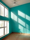 Empty house ambient with windows, a ceiling fan and turquoise walls