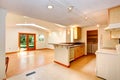 Empty house interior with open floor plan. Living room and kitchen area