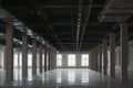 Empty huge open space in old factory building with rows of columns, big windows and pipes on the ceiling Royalty Free Stock Photo