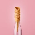 Empty ice cream cones in glass milk bottle against pink background Royalty Free Stock Photo