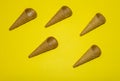 Empty ice cream cones on a yellow background. Minimalist design composition Royalty Free Stock Photo