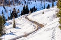 View form above of a deserted snowy mountain road on a sunny winter day Royalty Free Stock Photo