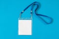 Empty ID card badge icon with blue belt, on blue background. Royalty Free Stock Photo