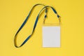 Empty ID card badge icon with blue belt, on yellow background. Royalty Free Stock Photo