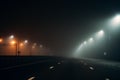 Empty illuminated by city lamps foggy road at night in misty weather Royalty Free Stock Photo