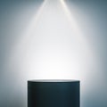Empty illuminated pedestal in interior with copy space Royalty Free Stock Photo