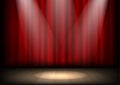 Empty illuminated theatre stage with red curtains and spotlight