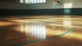 Empty indoor basketball court with sunlight streaming through windows Royalty Free Stock Photo