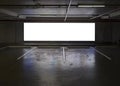 Empty Indoor car park with blank billboard at night time Royalty Free Stock Photo