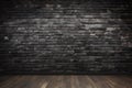 Empty indoor rough black brick wall with wooden floor. Loft room interior. Copy space Royalty Free Stock Photo