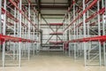Empty industrial warehouse building with rows of racks Royalty Free Stock Photo